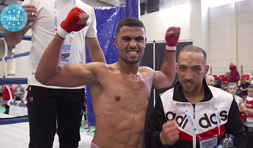 Kickboxing athlete celebrating with a coach after competition