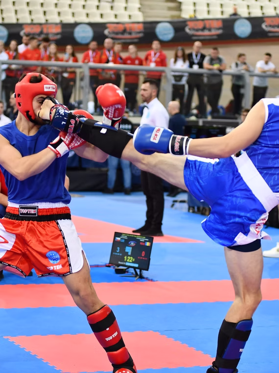Kickboxer landing a high kick during competition