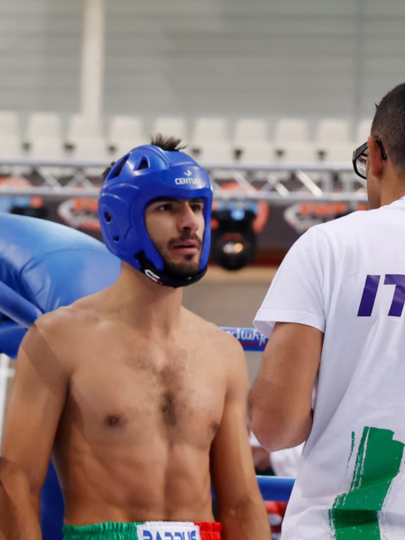 Kickboxing competitor wearing protective headgear before a bout