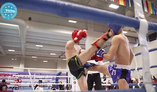 Two kickboxers exchanging a kick during a supervised ring bout