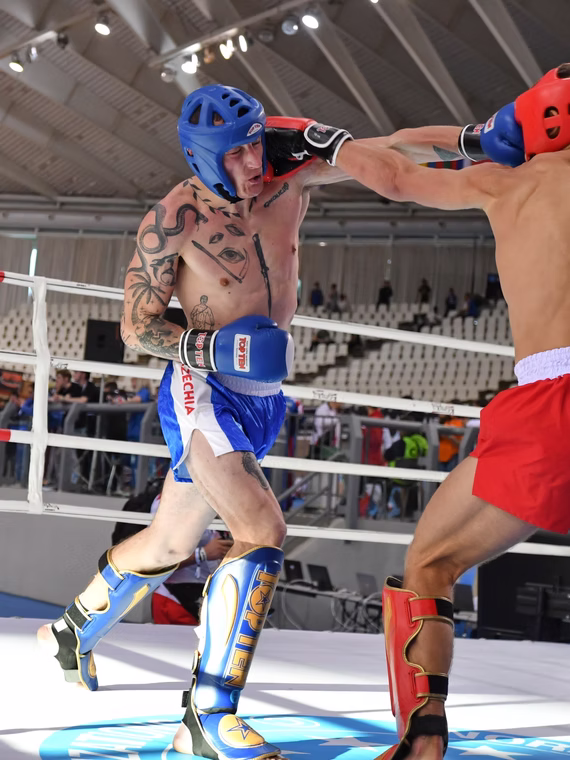 Two kickboxers exchanging punches during a ring bout