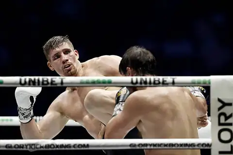 Two kickboxers competing in a ring during a striking exchange