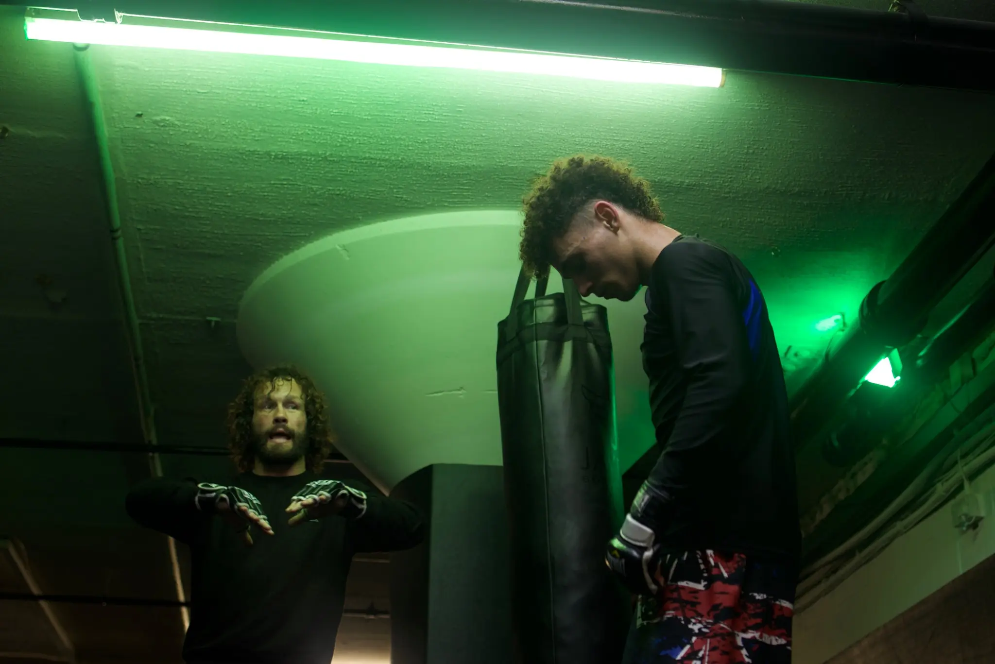 Tom Mearns coaching MMA under the green lights at Onyx Combat Academy Northampton